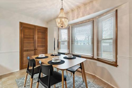 a dining room with a table and chairs and windows at 3 Bed 2 Bath Home w 2 Car Garage & Fitness Room in Wichita