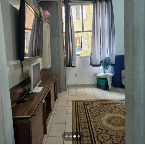 uma casa de banho com um lavatório, uma secretária e uma janela em Aconchego a Beira Mar em São Vicente
