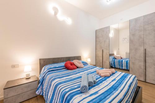 a bedroom with a large bed with towels on it at Lucky Flat, un momento di relax. in Milan