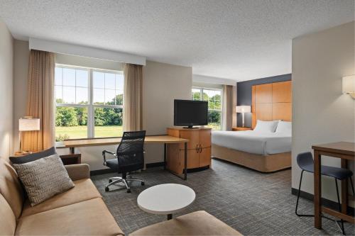 a hotel room with a bed and a couch and a desk at Residence Inn Mt. Laurel at Bishop's Gate in Mount Laurel