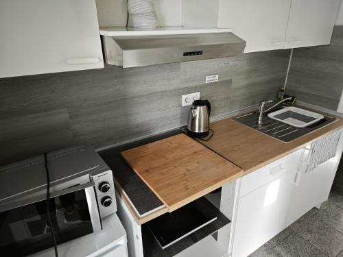 a kitchen with a wooden counter top and a sink at Smart Appart in Cologne