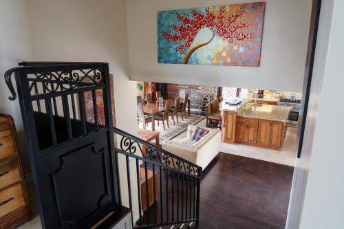 a staircase leading to a kitchen with a painting on the wall at Stunning Home & Spectacular View in La Mesa