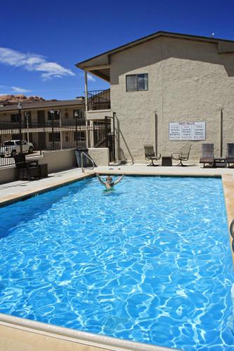 a person in a swimming pool at a hotel at Bowen Motel in Moab