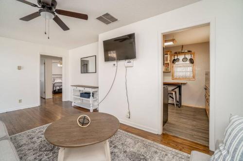 a living room with a table and a ceiling fan at 2 Bed 1 Bath Home w 2 Car Garage & Fenced Yard in Wichita