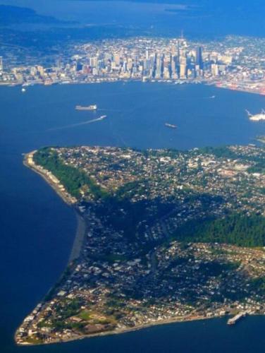 an island in the middle of a large body of water at Alki Beach Cottage, NEW, 2 bedrooms, 2 bathrooms, near beach, AC, WD, Parking in Seattle