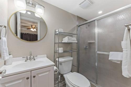 a bathroom with a shower and a toilet and a sink at 2 Bed 2 Bath 1st Floor Condo w Pool By Beach in South Padre Island