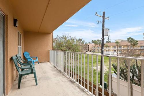 a balcony with a blue chair and a pole at Lovely 2 Bed 2 Bath 2nd Floor Condo By Beach in South Padre Island