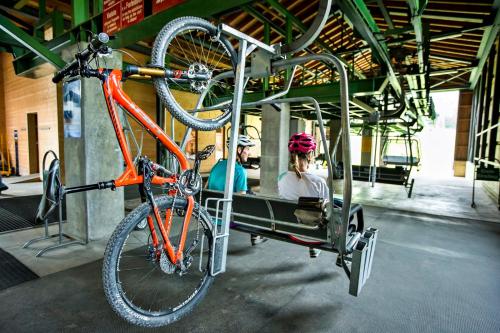 a bike hanging from a bike rack on a car at Rancho Laaxdeluxe in Laax