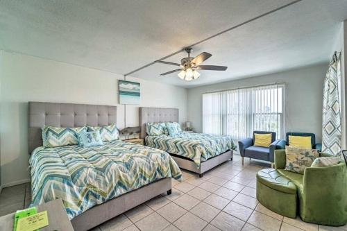 a bedroom with two beds and a ceiling fan at 1 Bedroom Studio Near Beach w Pool & Amenities in South Padre Island