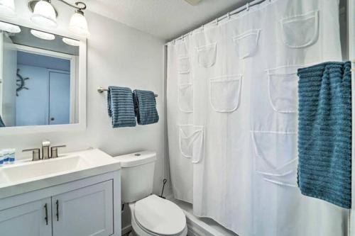 a bathroom with a white shower curtain and a toilet at 1 Bedroom Studio Near Beach w Pool & Amenities in South Padre Island
