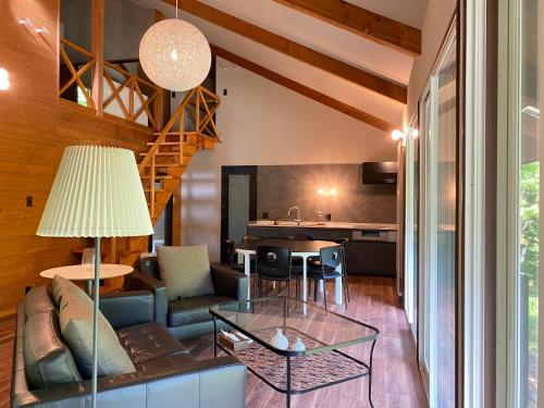 a living room with a couch and a table at ユニテ蔵王ジョーニダ リゾート in Yamagata