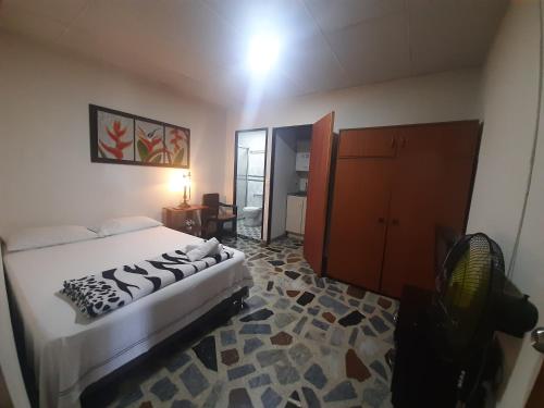 um quarto com uma cama e um quarto com um espelho em CERCA AL AEROPUERTO CONTRALORIA AL LADO HOTEL TORREON No ES DOS QUEBRADAS MEDIA CUADRA ESTACION UCUMARI 30 AGOSTO em Pereira