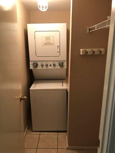 a washer and dryer in a small room at 1st Floor 2 Bd 2 Ba Condo w Beach View& Pool in South Padre Island