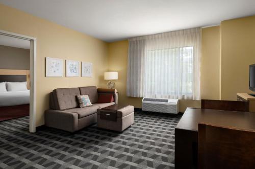 a hotel room with a couch and a bed at TownePlace Suites Ann Arbor in Ann Arbor