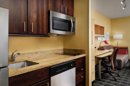 a kitchen with a sink and a microwave at TownePlace Suites Ann Arbor in Ann Arbor