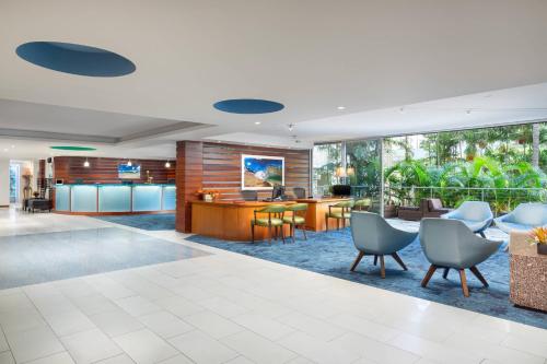 an office lobby with a reception desk and chairs at Courtyard by Marriott Waikiki Beach in Honolulu