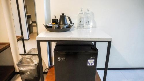a small table with a sink and bottles on it at JW NAUNGAN COLIVING in Solo