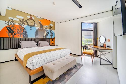 a bedroom with a large bed and a desk at JW NAUNGAN COLIVING in Solo