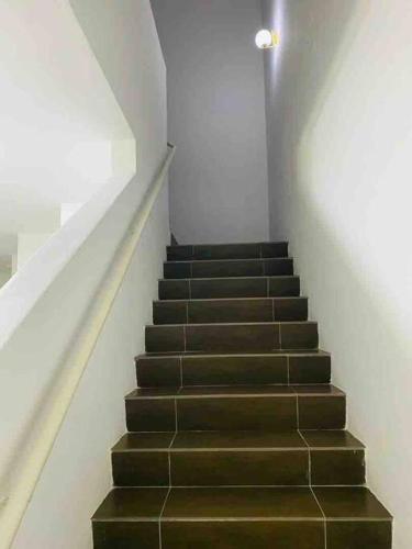 a staircase in a building with a stair case at Afrinas Islamic Homestay Banting in Banting