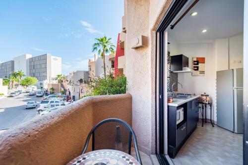 a balcony with a kitchen and a view of a street at Marina Cabo Plaza Town & Beach Condos in Cabo San Lucas