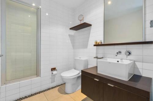 a bathroom with a toilet and a sink and a shower at 347 Paradiso Kingscliff Beach 3 Bedroom Private Rooftop in Kingscliff