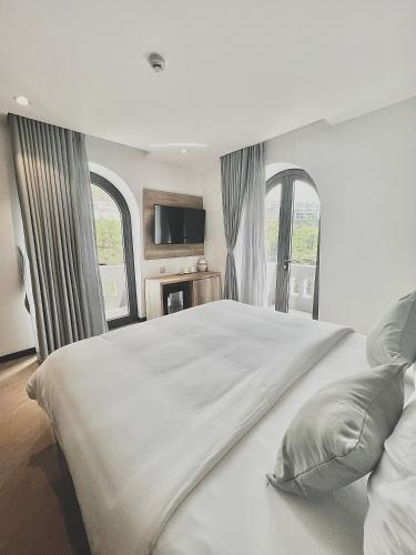 Giường trong phòng chung tại La Sera Suites Nha Trang