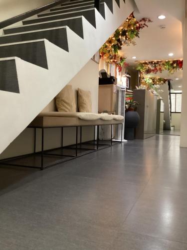 a living room with a couch under a staircase at D' Residences in Cebu City