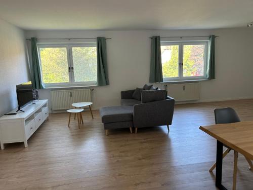 a living room with a couch and a table at FeWo Beim Museumsdorf in Buchholz in der Nordheide