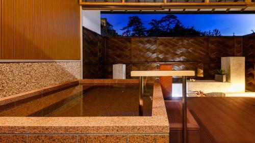 a lobby with a table in the middle of a building at リゾートホテル美萩 in Hagi