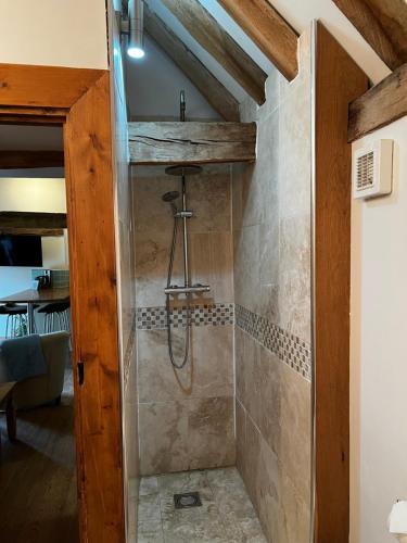 a bathroom with a shower in a room at Charming Bluebell cottage - lake views nr Tenterden & Rye in Rolvenden