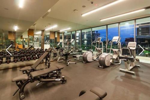 a gym with a lot of cardio equipment in a building at Moderno Luxury Suite@Robertson Kuala Lumpur in Kuala Lumpur