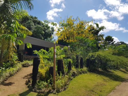 a garden in front of a house at Stay at Eden on the River in Port Vila