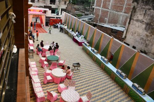 an overhead view of a patio with pink tables and chairs at Hotel Kusum Palace in Gaya