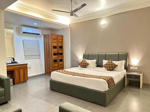 a bedroom with a large bed in a room at Nexstay Kassaba Inn in Kozhikode