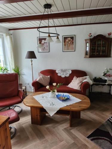 a living room with a couch and a coffee table at Ferienhaus Katinka in Krummhörn