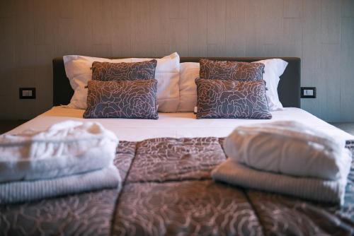 a bed with two pillows on top of it at Casa Grimaldi Hotel & Restaurant tre stelle S in Matelica