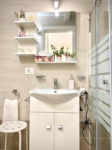a bathroom with a sink and a mirror at Loft Agata - host Marco cell.339/3860587 in Polistena