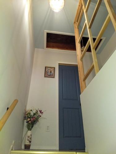 a blue door in a room with a staircase at Explore New York from Queens in Queens
