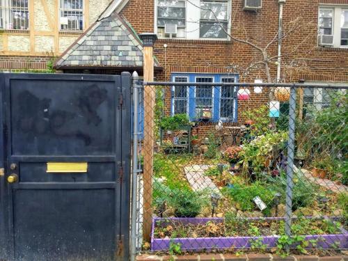 a garden behind a fence with a gate at Explore New York from Queens in Queens
