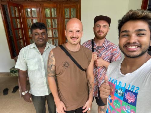a group of men posing for a picture at Summer Ridge - Homestay in Ratnapura