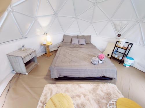 a bedroom with two beds in a yurt at ภูชวนหลง ม่อนแจ่ม in Chiang Mai