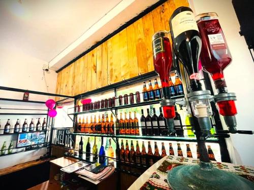 a bar with a bunch of bottles of alcohol at Lake View Resort in Pamunugama