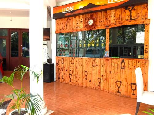 a restaurant with a wooden facade with a wooden floor at Lake View Resort in Pamunugama