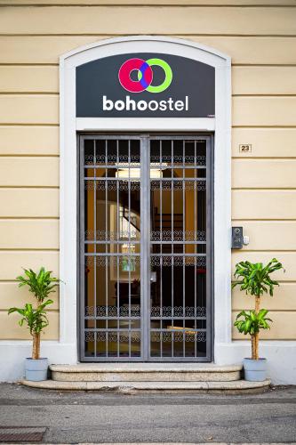 a building with a door with a sign on it at Bohoostel in Bologna