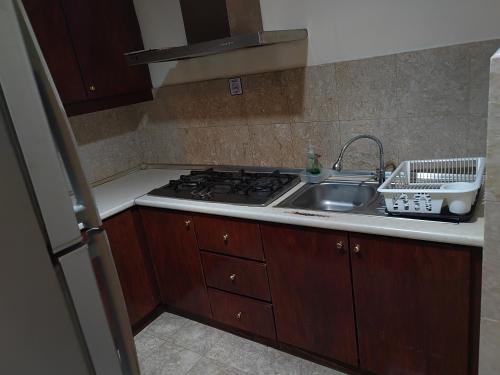 a kitchen with a sink and a stove at Kl Continew Suite At Times Square in Kuala Lumpur