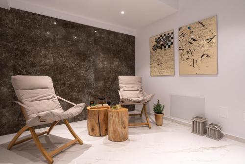 two chairs and a table in a room at SOPHID Wellness Suites Karpathos in Karpathos Town