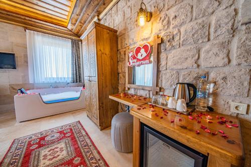 a bathroom with a fireplace and a bath tub at Remus Romulus Cappadocia in Uçhisar