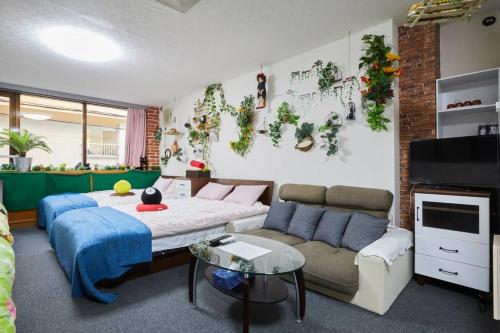 a living room with a couch and a tv and a couch at TokyoGuest Akihabara in Tokyo