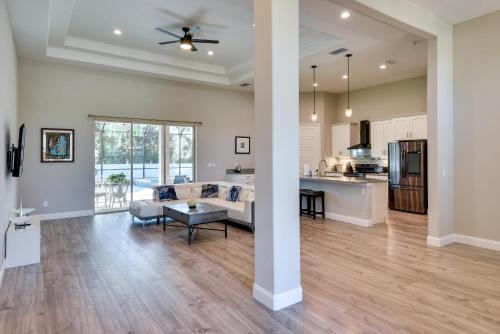 a living room and kitchen with a couch and a table at Palm Coast Family Retreat with Private Pool! in Palm Coast
