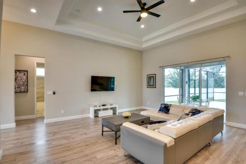 a living room with a couch and a ceiling fan at Palm Coast Family Retreat with Private Pool! in Palm Coast